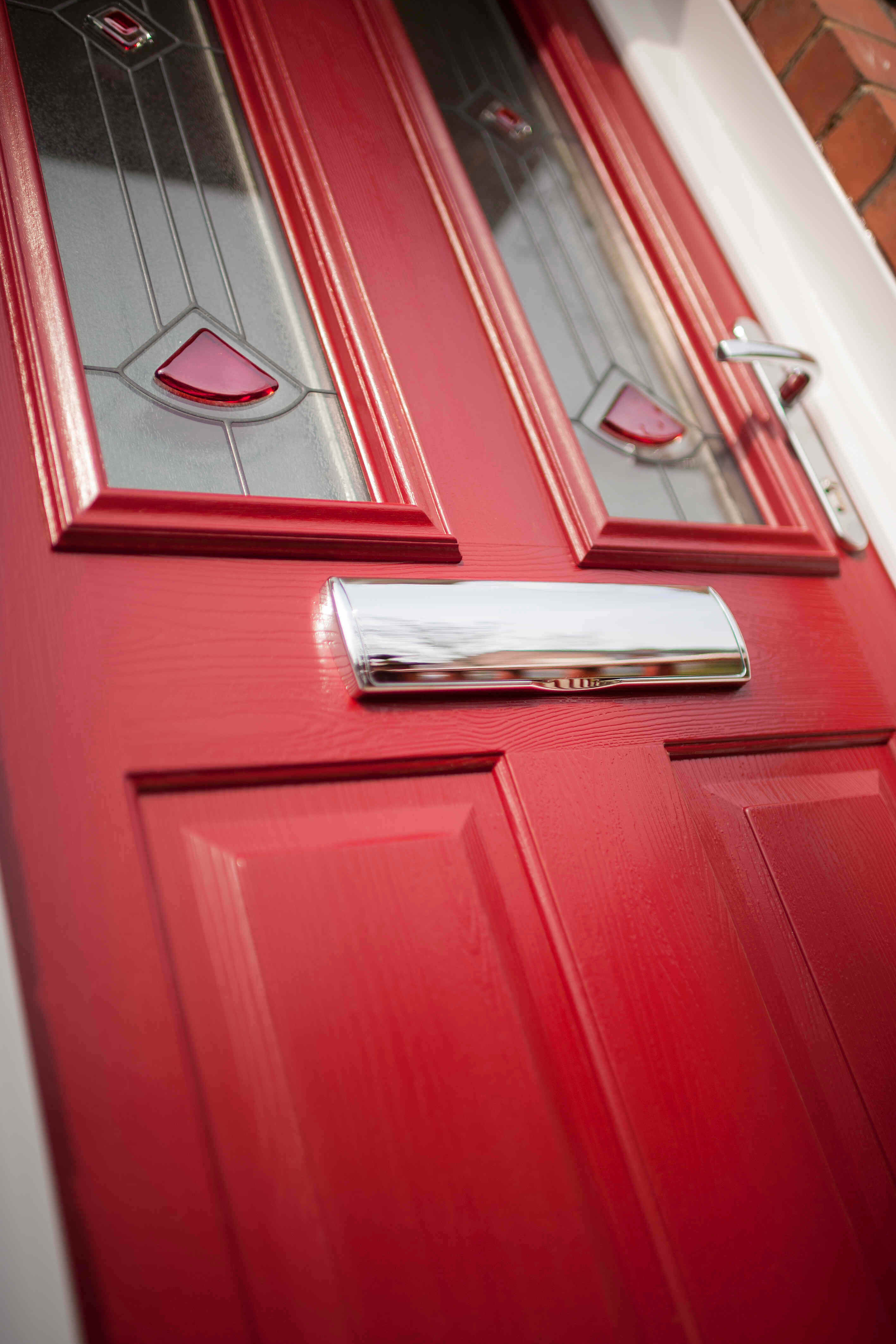 Red door with silver handle and letterbox